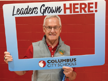 Jim Tressel holding a cutdown of leaders grown here